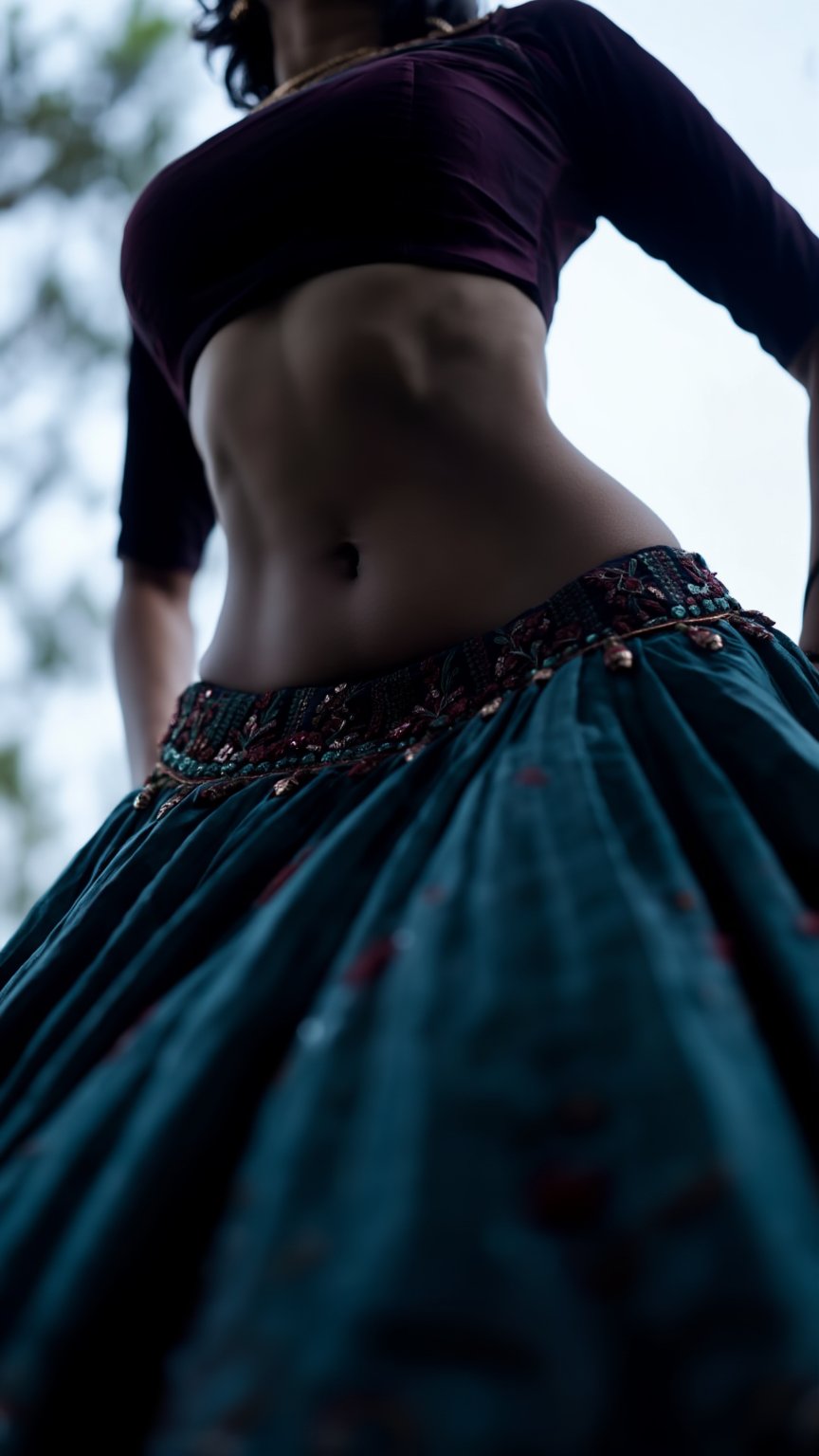 Low-angle,  young Indian woman with a fit hourglass figure,  ultra-low-rise low-waisted designer lehenga skirt by LoRa Fac...