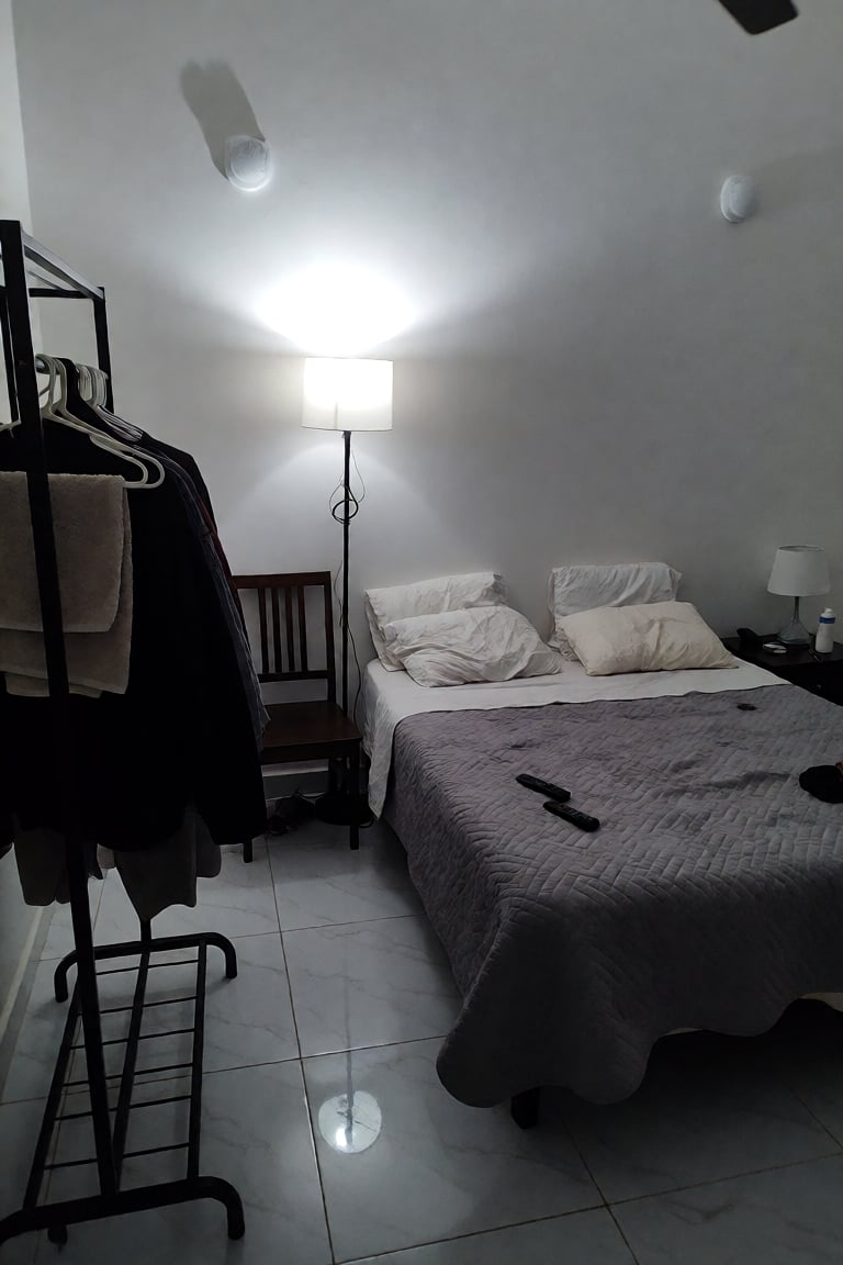 A medium-shot,  eye-level indoor photograph captures a simple,  minimalist bedroom with a neutral by Not_Juanamala on Tens...
