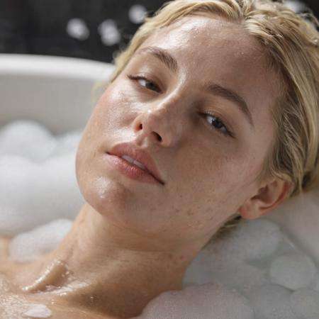 Cropped out face, A up close selfie photo of a 30 year old blonde Sensual woman enjoying bubble bath, ultra detailed, dramatic, atmospheric