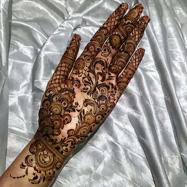 Designer Mehndi on hand, a beautiful hand, showing mehndi