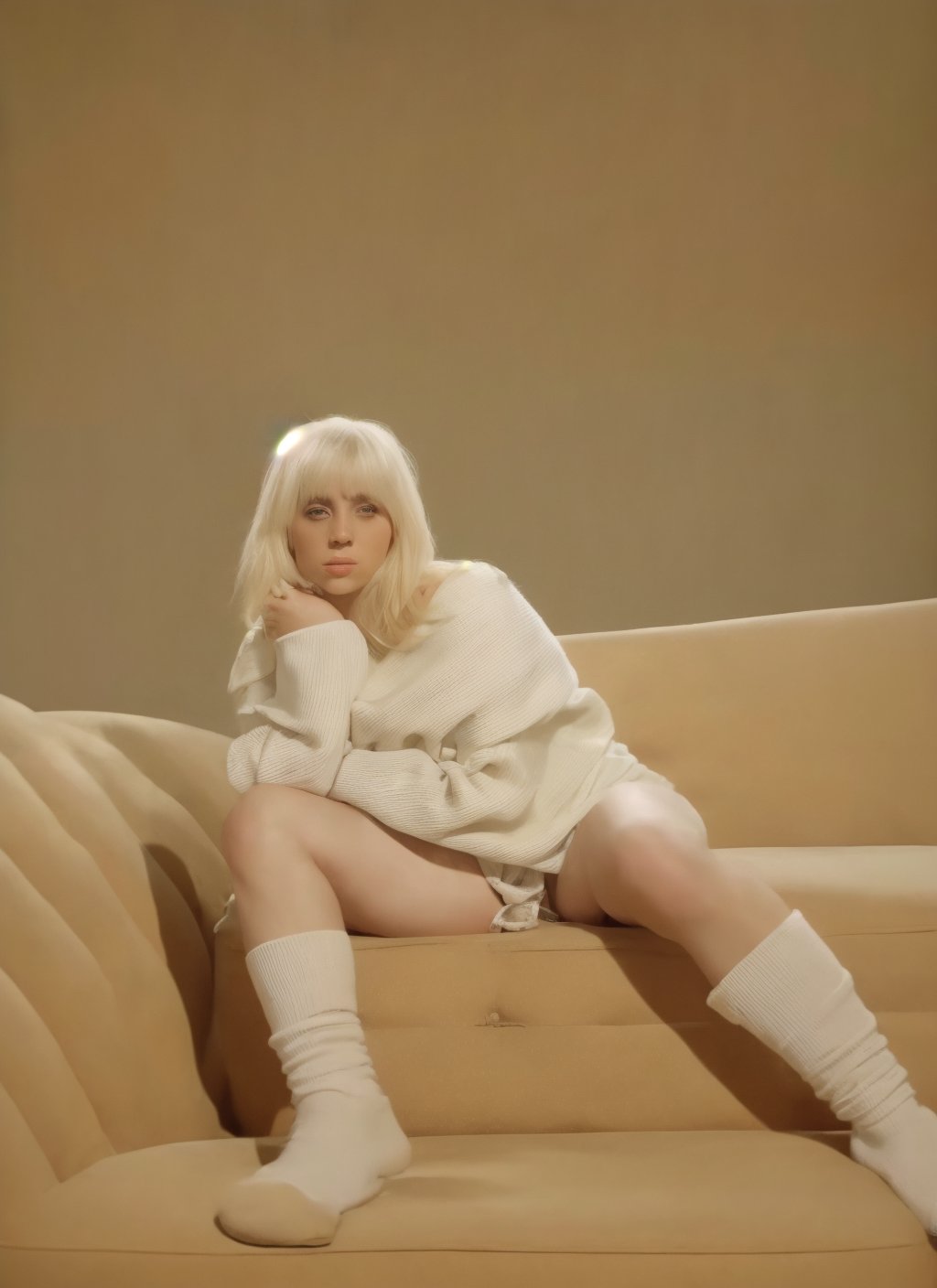 a woman with blonde hair and a white sweater sitting on the sofa, white socks, beige background, sofa in the background