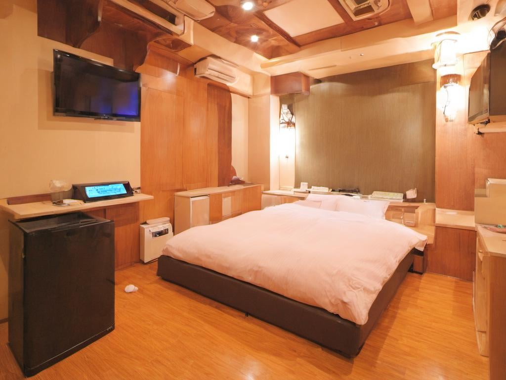 masterpiece, best quality, ultra-detailed, illustration,lovehotel, LHbedpanel, bed, indoors, scenery, lamp, bedroom, television, pillow, monitor, cabinet, light, window, door, table, wooden floor, <lora:Lovehotel_SDXL_V1:1>