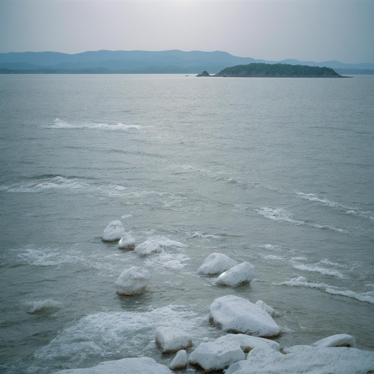 cinematic film still of  <lora:Ron Fricke style SD1.5:1>a view of a body of water with a lot of white rocks,outdoors,day,water,no humans,ocean,scenery,blue theme,underwater , realistic, realism, movie still, film grain, kodak film, film contrast, film color, cinematography, documentary, photography, 70 mm film, 65 mm film, Todd-AO, Todd-AO 35, 8K resolution, Ron Fricke film director style, Ron Fricke film directing style, Ron Fricke style, shallow depth of field, vignette, highly detailed, high budget, bokeh, cinemascope, moody, epic, gorgeous, film grain, grainy