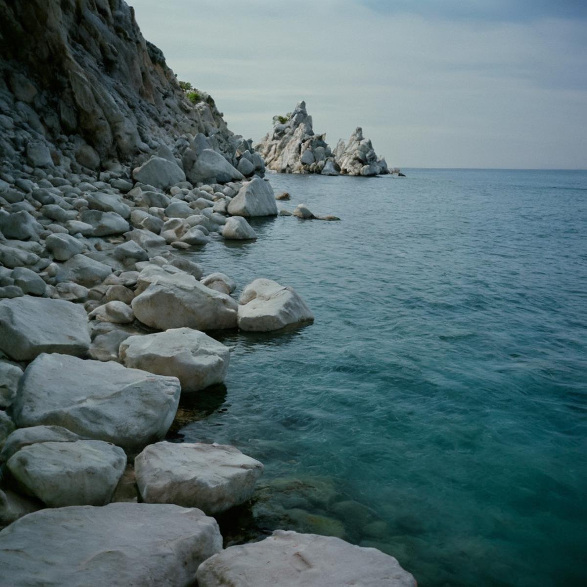 cinematic film still of  <lora:Ron Fricke style v2:1>a view of a body of water with a lot of white rocks,outdoors,day,water,no humans,ocean,scenery,blue theme,underwater , realistic, realism, movie still, film grain, kodak film, film contrast, film color, cinematography, documentary, photography, 70 mm film, 65 mm film, Todd-AO, Todd-AO 35, 8K resolution, Ron Fricke film director style, Ron Fricke film directing style, Ron Fricke style, shallow depth of field, vignette, highly detailed, high budget, bokeh, cinemascope, moody, epic, gorgeous, film grain, grainy