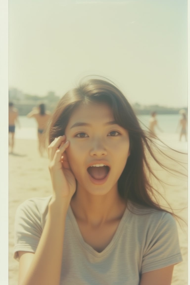 A Polaroid photo of a Korean woman with an excited expression, captured at the beach. The image features soft, natural lighting, focusing on her animated face and casual attire. The composition is candid, with the beach setting visible in the background.