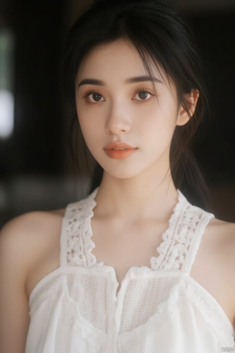 a close-up shot of a young Asian woman with dark brown hair and brown eyes. She is wearing a white sleeveless blouse with a low neckline that is adorned with white embroidery. Her hair is pulled back in a ponytail, adding a touch of texture to her face. The backdrop is blurred, creating a stark contrast to the woman's white dress.