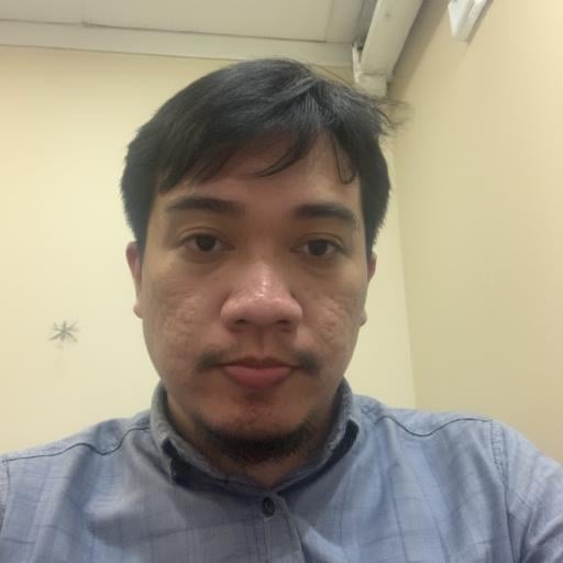 who appears to be of Southeast Asian descent,  arifaridho. The image is a photograph of a man with a calm and composed exp...