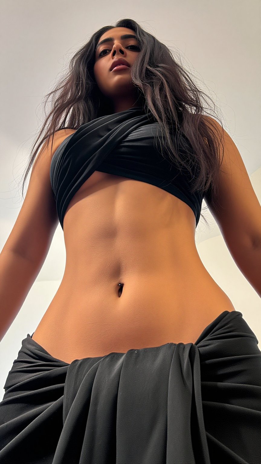 A worm’s-eye view low-angle shot captures a Mallu young slim woman with a seductive expression. Extreme low rais Low waist...