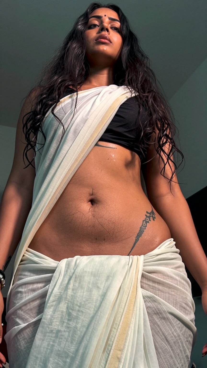 A worm’s-eye view low-angle shot captures a Mallu tattoo young slim woman with a seductive expression. Extreme low rais Lo...