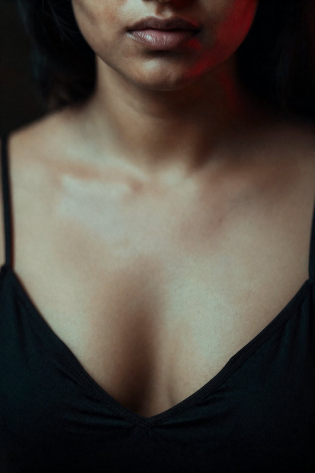 A beautiful south Asian woman face close up,  huge cleavage showing outfit,  fair skin in dark atmosphere theame by AI fac...