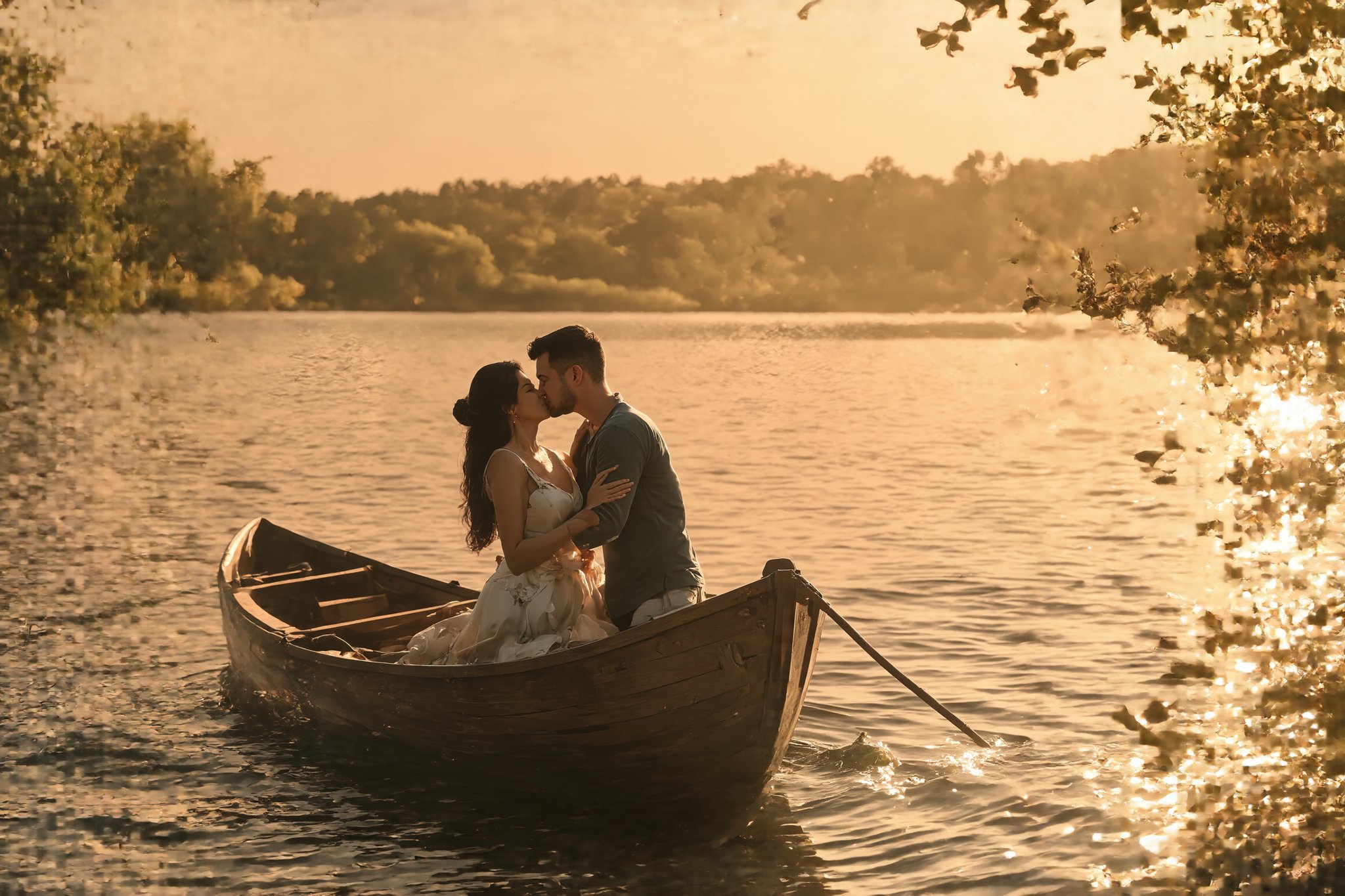 Romantic sunset over a tranquil lake. Couple kissing on a small wooden rowboat. Golden light reflecting on calm water. Man and woman in intimate embrace, silhouetted against vibrant orange and pink sky. Ripples around the boat, creating subtle reflections. Lush trees lining the distant shore. Long shadows stretching across the water's surface. Dreamy, soft focus atmosphere. Highly detailed, photorealistic style with painterly touches. 8K resolution, focus on the couple and immediate surroundings. Warm color palette emphasizing the romantic mood. Masterpiece quality, emotional impact.