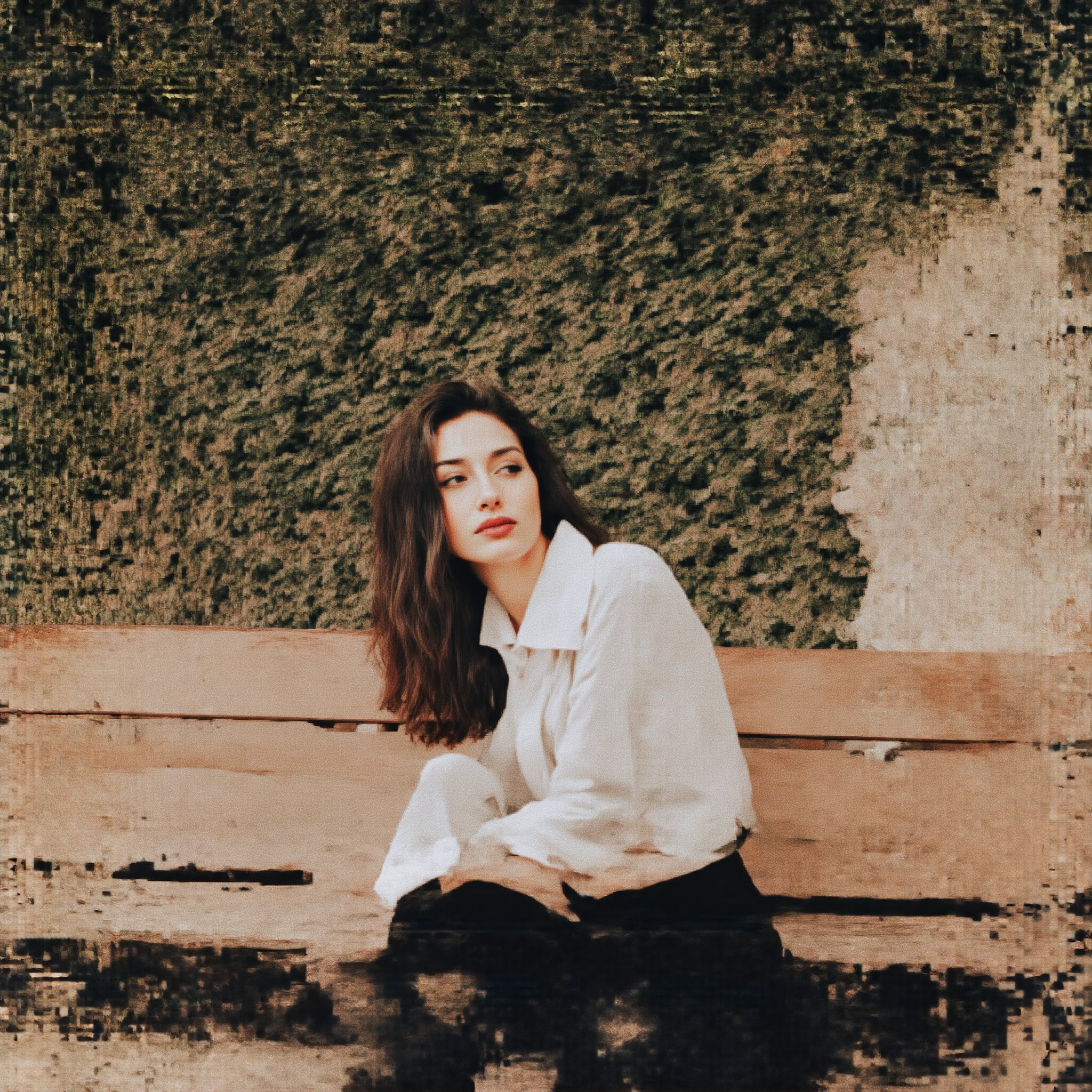 A solo portrait of a single girl, positioned in a subtle candid moment, sitting on a worn wooden bench with a weathered stone wall behind her. Soft natural light filters through the afternoon sun, casting a warm glow on her relaxed features and tousled hair. The framing captures her introspective gaze, as she leans slightly forward, her elbows resting on her knees, surrounded by lush greenery.