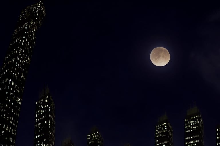 night, dark blue sky with blurry white clouds, full moon, black rectangular skyscrapers with small windows in which white light is visible, metal superstructures are visible at the tops of skyscrapers, brown cubes and a few gray cubes are visible at the base of skyscrapers, the earth is brown mud or clay, far focus, twinkling windows and stars, brilliant coloring, crispy quality, vray; Pixar, ; HD, HDR, SF, CGSociety, 16k, photorealistic, unreal engine