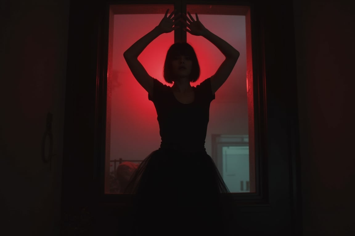 In a dimly lit room, a woman in a flowing black dress stands before a large glass window, her arms raised dramatically as if reaching for something beyond. The glass, framed by a shadowy black wall, reflects a haunting vibrant red light that seeps into the space, creating a stark contrast. Her face remains obscured in the shadows, with a sleek bob hairstyle adding to the mystery. She wears a fitted black t-shirt beneath her dress, blending into the darkness. The background fades into a blurred, stark white wall, adding an unsettling pop of color to the scene, enhancing the overall cinematic feel.