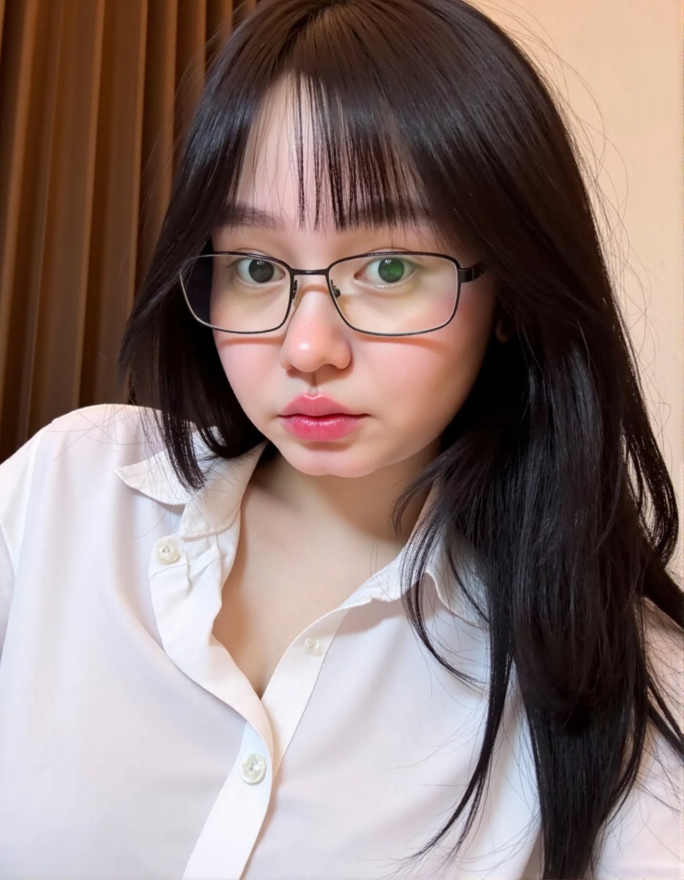 Photograph of a young Asian woman with long black hair wearing glasses and a white shirt. She has a round face light skin...
