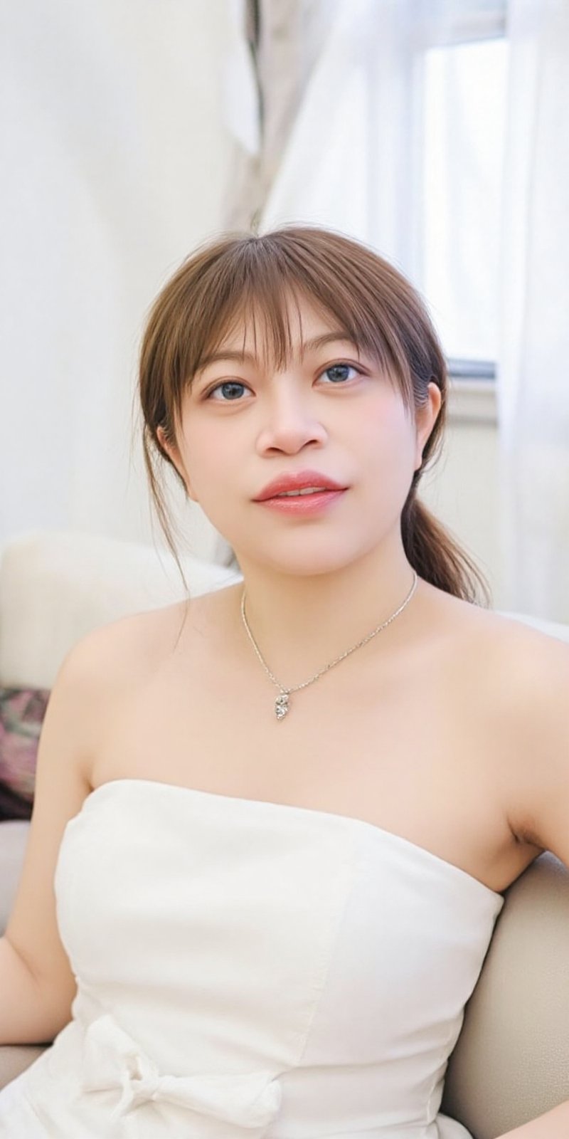 a young Asian woman,  dressed in a white strapless dress,  is seated on a beige couch. She is smiling by 70Super_Motor🛵🛵...
