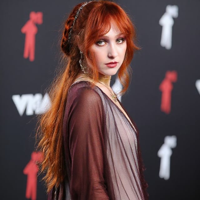 a woman,orange hair,perfect face,Chappell Roan, young, in a brown dress, red carpet, vmas