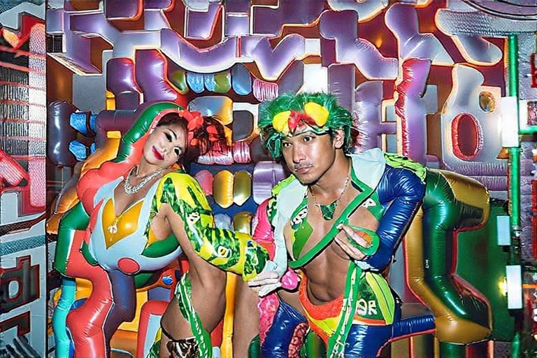 An award winning journalist Photograph, of a man and a woman wearing multi-colored inflatable outfits, in a funky love hotel having sexual intercourse, well lit cinematic lighting, complex shadows, extremely detailed , hotshoe flash on subject, text reads:"love hotel" , 1990s Photoshop style