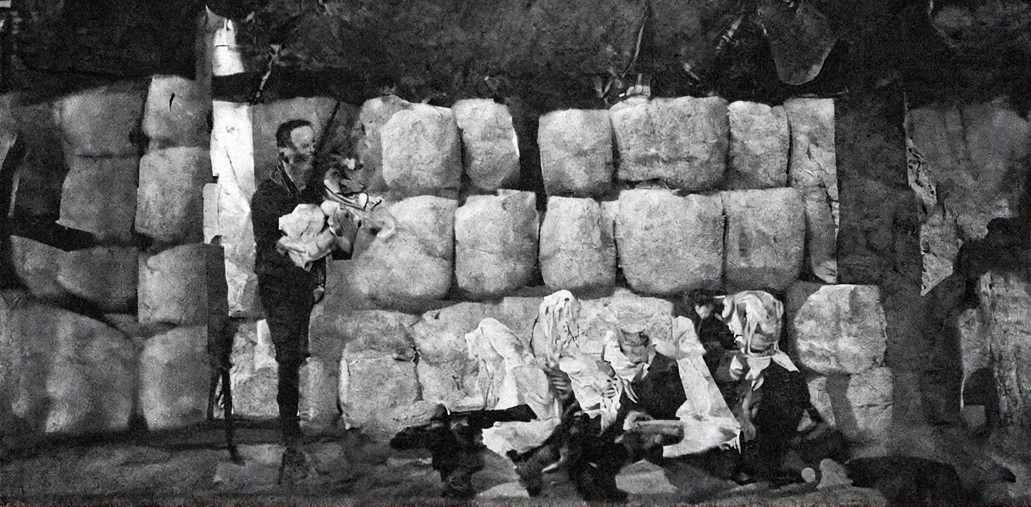 A stark black and white composition: a group of individuals, dressed in rustic attire, congregates around an enormous stack of pristine ceramic vessels. The men don worn hats, while the women's long-sleeved shirts and shorts evoke a sense of modesty. Some males grasp wooden staffs, others sit cross-legged on the earth. In the distance, two thatched huts stand sentinel, their rustic simplicity contrasting with the vibrant colors of the gathering.