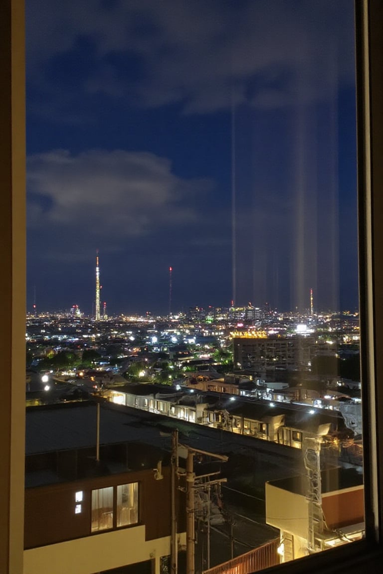 The photo was taken from the window of the room looking out with a view of dense Japanese housing, this photo was taken right at night