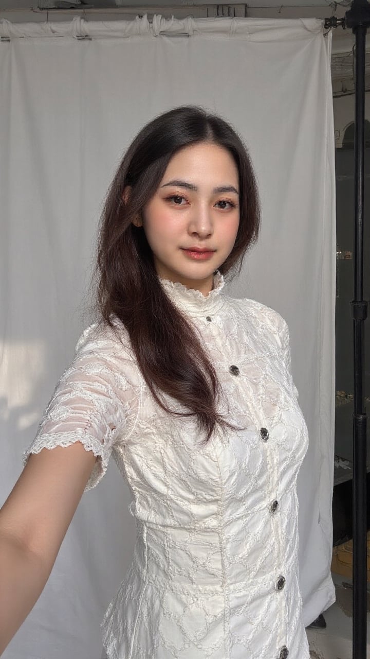 A young woman in a turtleneck dress with lace pattern stands in a photo studio. The shot is framed close-up,  focusing on...