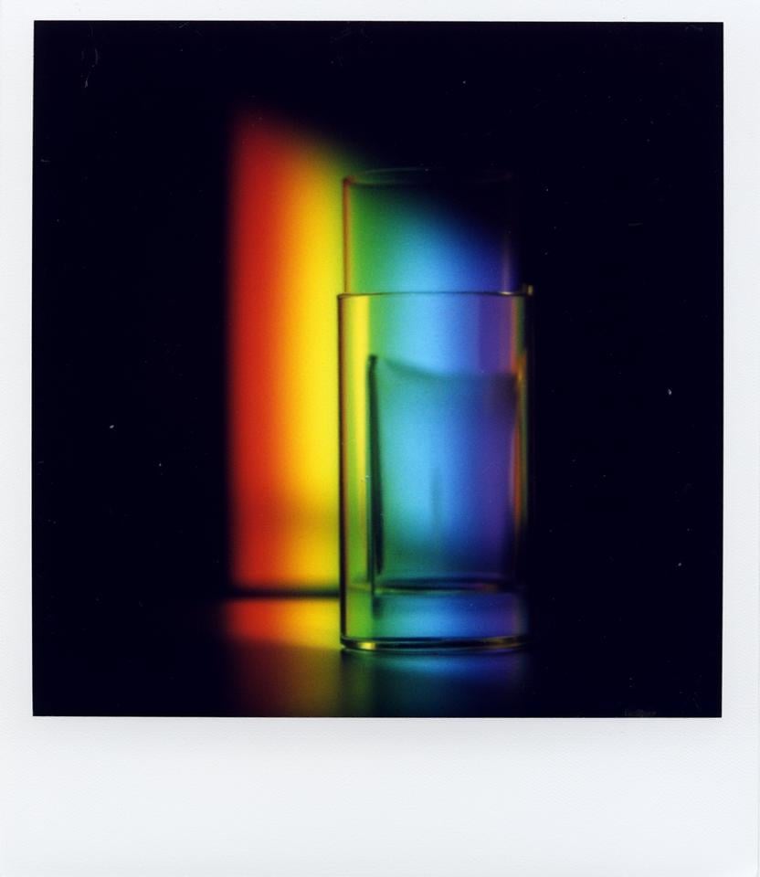 Polaroid of abstract rainbow, perpendicular lines, dark background, glas, stripes, perspective <lora:Polaroid_Flux:1.0><lora:ComfyUI_30404_:0>