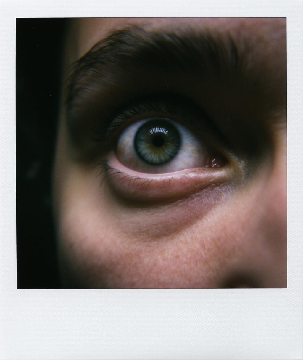 Polaroid frame of close up shot of very realistic portrait shot of an anxious looking eye, highly detailed, cinematic <lora:Polaroid_Flux:1.0><lora:ComfyUI_30729_:0>