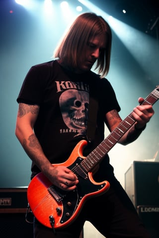 A metalhead guy with lots of tattoos on stage with an electric guitar