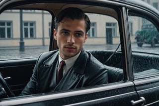 Generate an image of a young and handsome man waiting inside his car, his gaze fixed on a typical Berlin street corner as he anticipates the arrival of a comrade. Capture the scene from inside the car, providing a view through the window. Incorporate the atmospheric element of rain to enhance the mood. Pay attention to details such as the architecture of the Berlin street and the historical context of the setting. Emphasize the anticipation and camaraderie in the air, creating a visual narrative that reflects the historical and emotional elements of the Weimar Republic era. sdxl