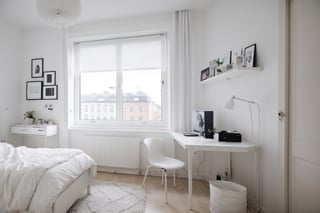 A female student's own room, simple, white walls, window frames, daytime