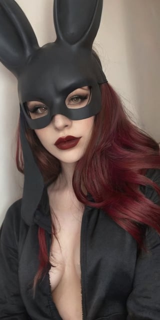 bunny mask, Generate hyper realistic image of a beautiful woman with dark red, lustrous hair cascading down, wearing a black oversized hoodie. Her long hair partially covers her face as she looks shyly at the viewer. Adorned in gothic makeup with big red lips and a pale complexion, she exudes a teasing smile inside a dimly lit bedroom. The contrast between the cozy oversized hoodie and the gothic allure adds a unique charm to the scene.,