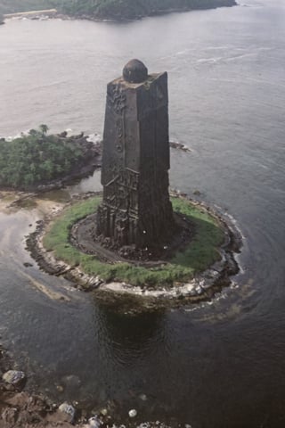 Low quality photos, footage taken by accident, old photos,Handheld camera images, subtitles, time stamps,
Aerial view of a huge jet-black monolith protruding from an uninhabited island, seen from above, the monolith is decorated with mysterious and mechanical geometric patterns, creating a striking contrast to the natural environment of the island ,VHSfootage,DonMSt34mPXL,island