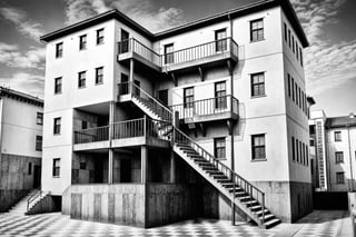 a black and white photo of a building with stairs, a detailed drawing by MC Escher, shutterstock contest winner, abstract illusionism, ray tracing, ambient occlusion, surrealist, Generative AI 