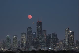 light bluish gray-light skyscrapers, sometimes with a light greenish tint, with frequent square windows, above two skyscrapers there is a red diode warning aircraft; with a dark gray sky and a clear gray sky illuminated by a bright white-blue moon